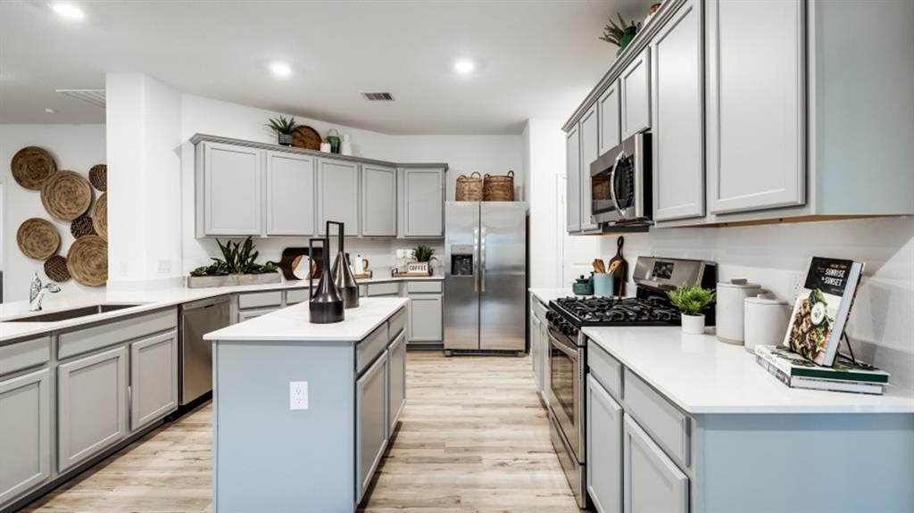 a kitchen with a sink stove top oven and cabinets