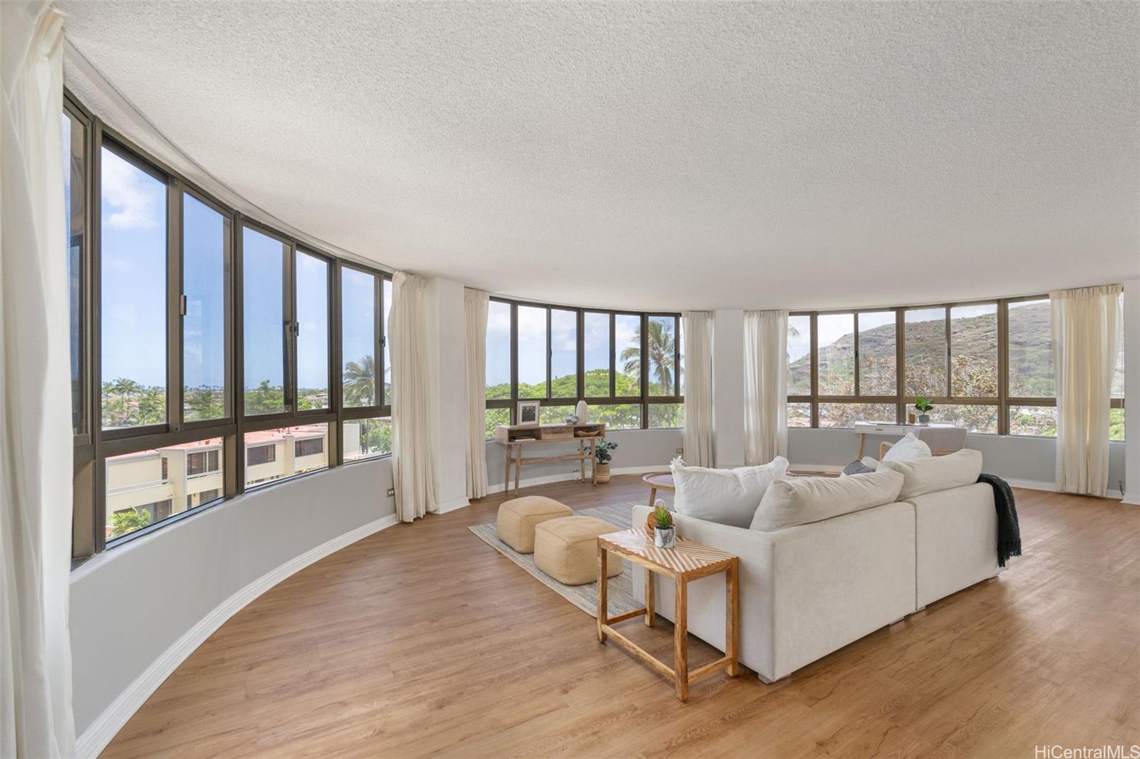 a living room with furniture and a large window with outer view