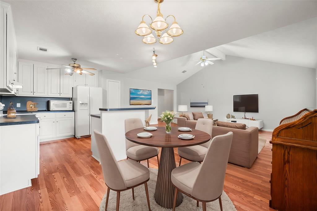 a view of a dining room with furniture and wooden floor