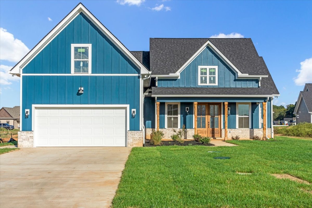 a front view of a house with a yard and garage