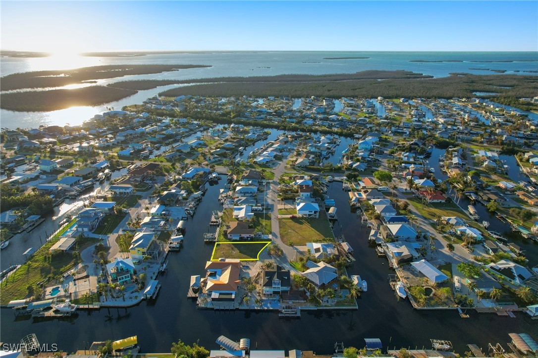 an aerial view of residential houses with outdoor space and swimming pool