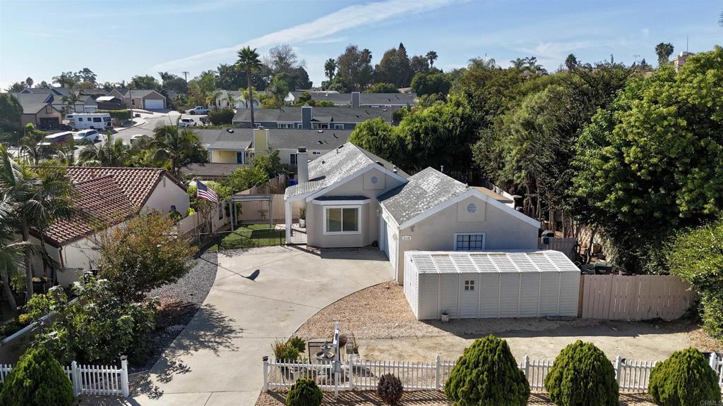 an aerial view of a house with a yard basket ball court and outdoor seating