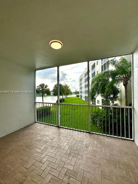 a view of a porch with a floor to ceiling window next to a yard