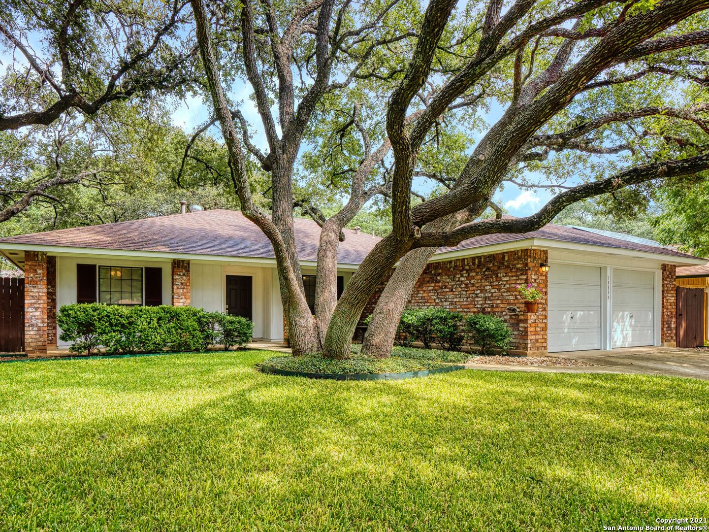 a front view of house with yard and green space