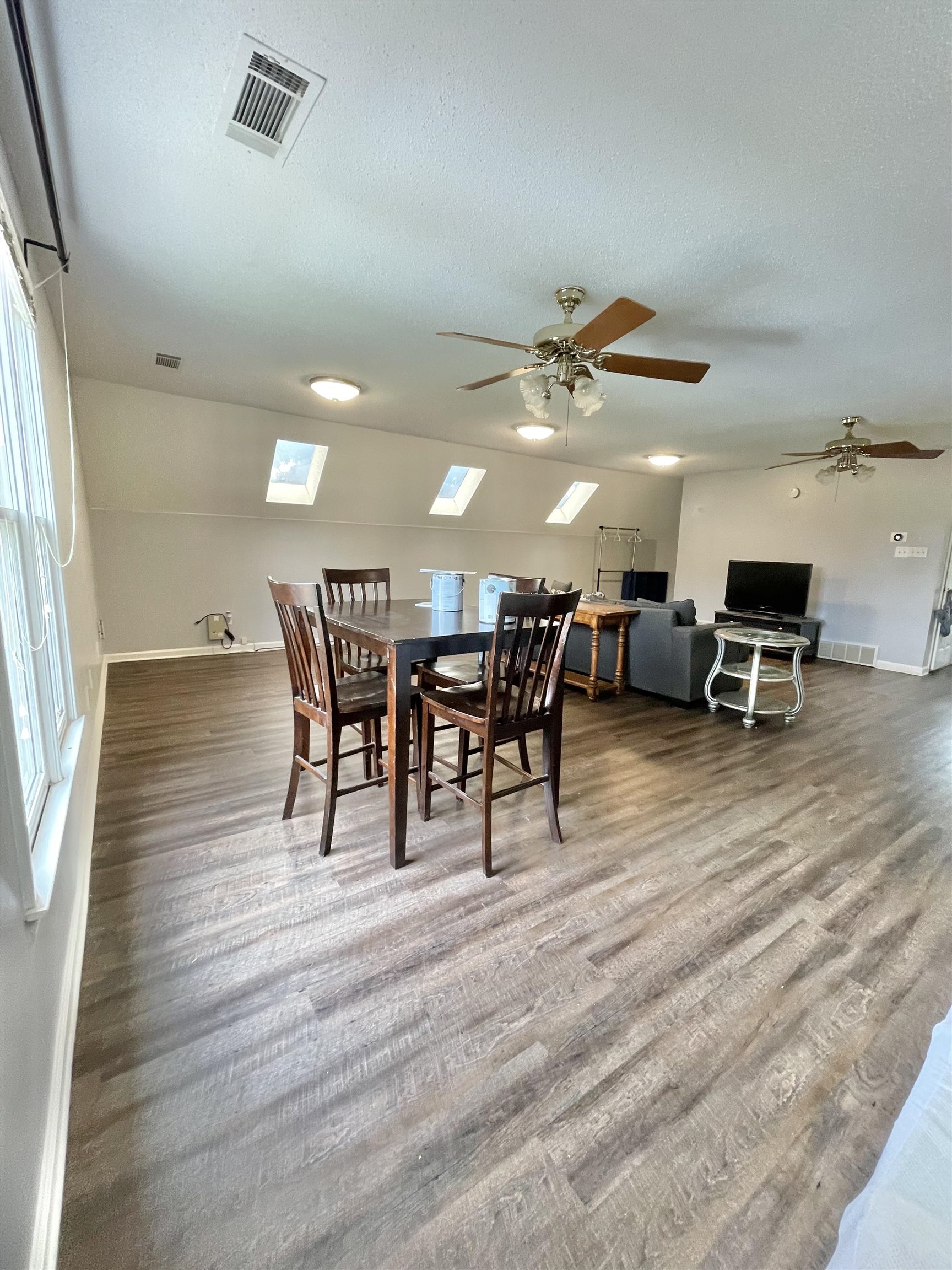 a view of a dining room with furniture and wooden floor