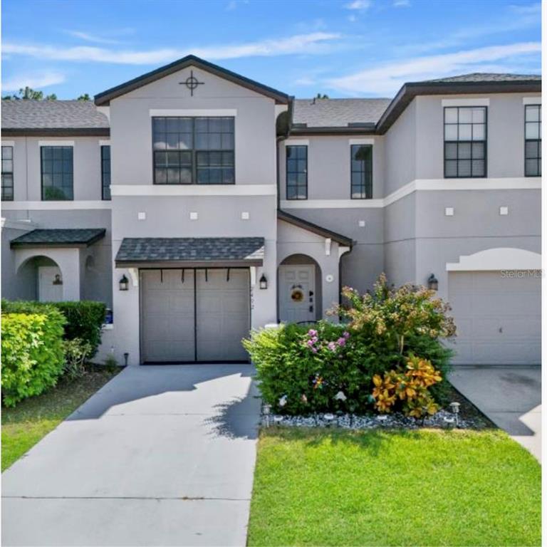 a front view of a house with a yard and garage