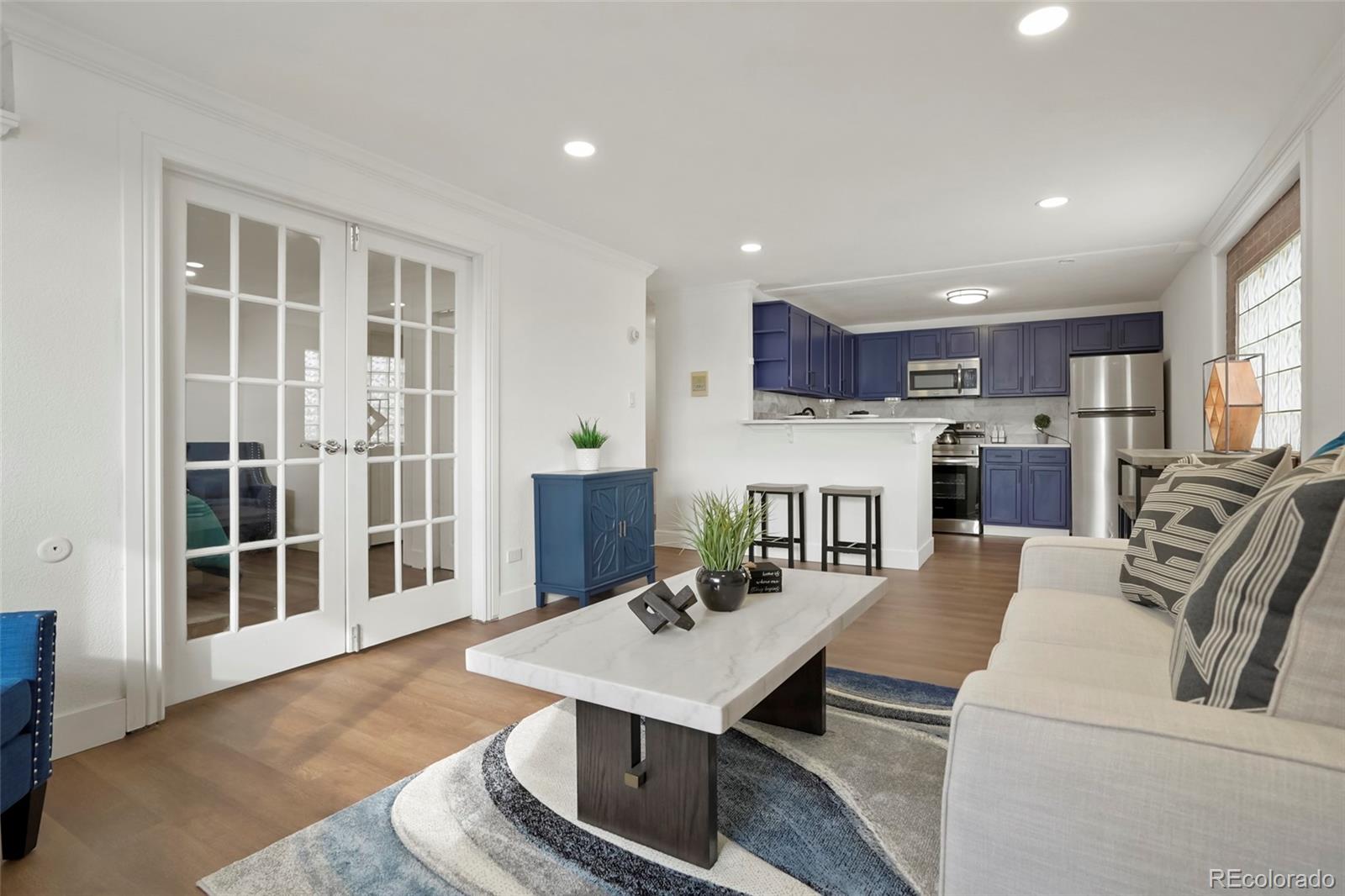 a living room with furniture and a kitchen