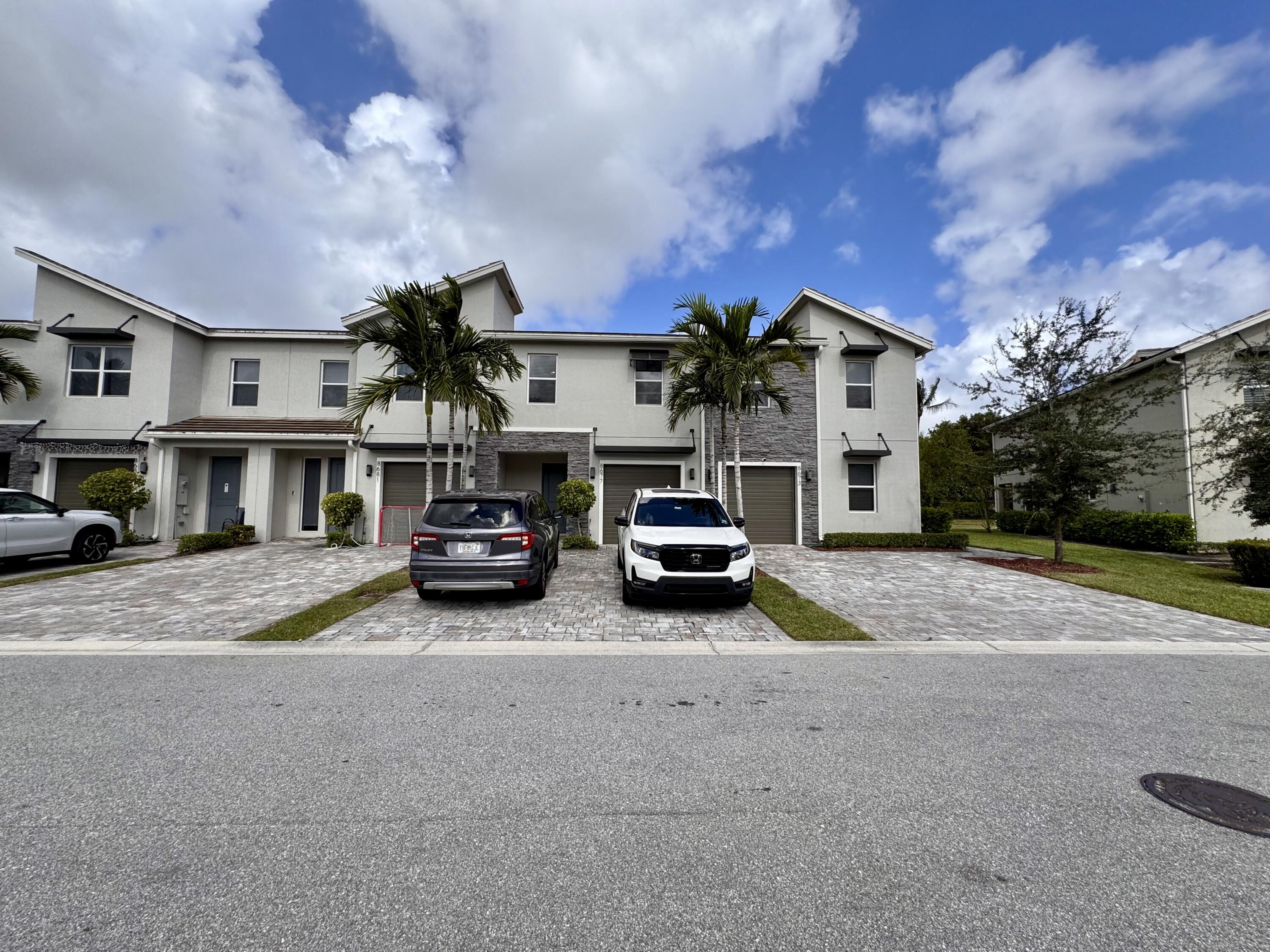 a view of a car park in front of house