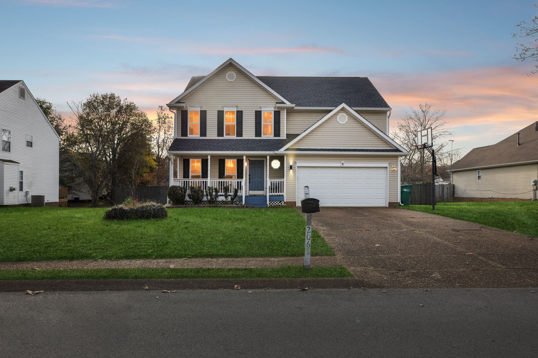 a front view of a house with a garden and plants