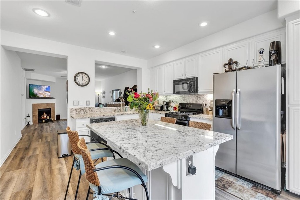 a kitchen with granite countertop center island and stainless steel appliances