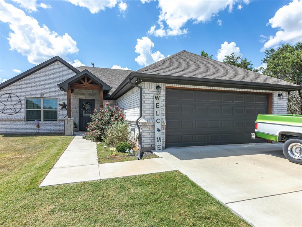 a front view of a house with a yard