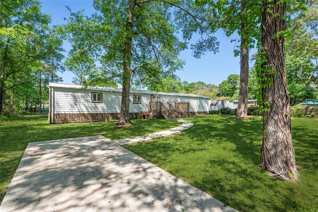 a view of a house with backyard and a tree