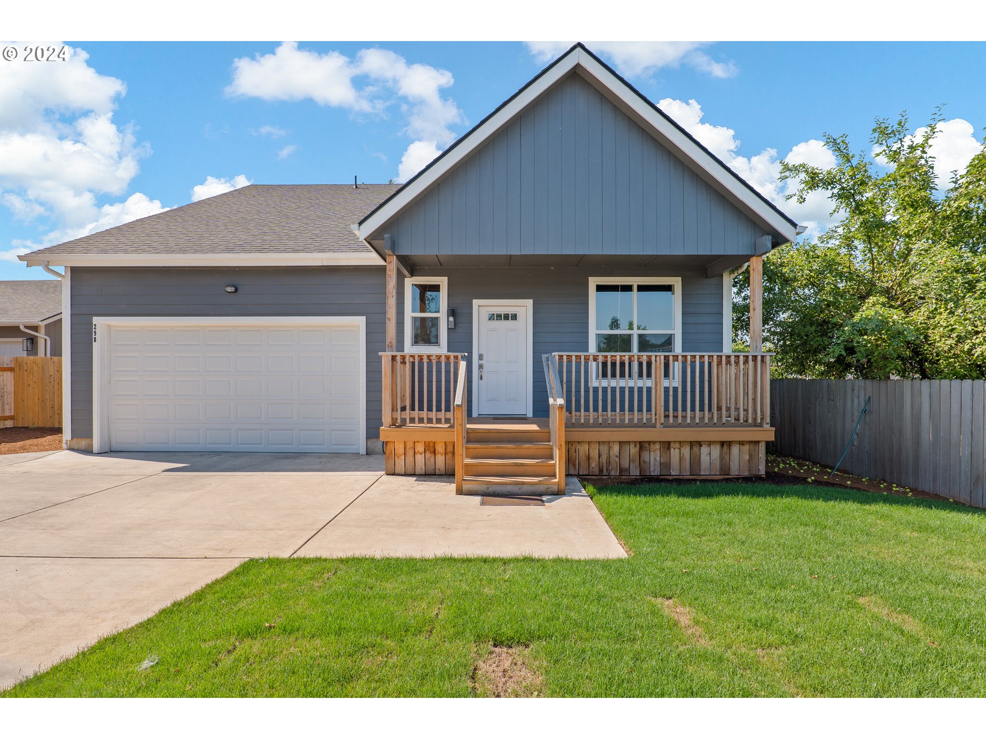 a front view of house with yard and garage