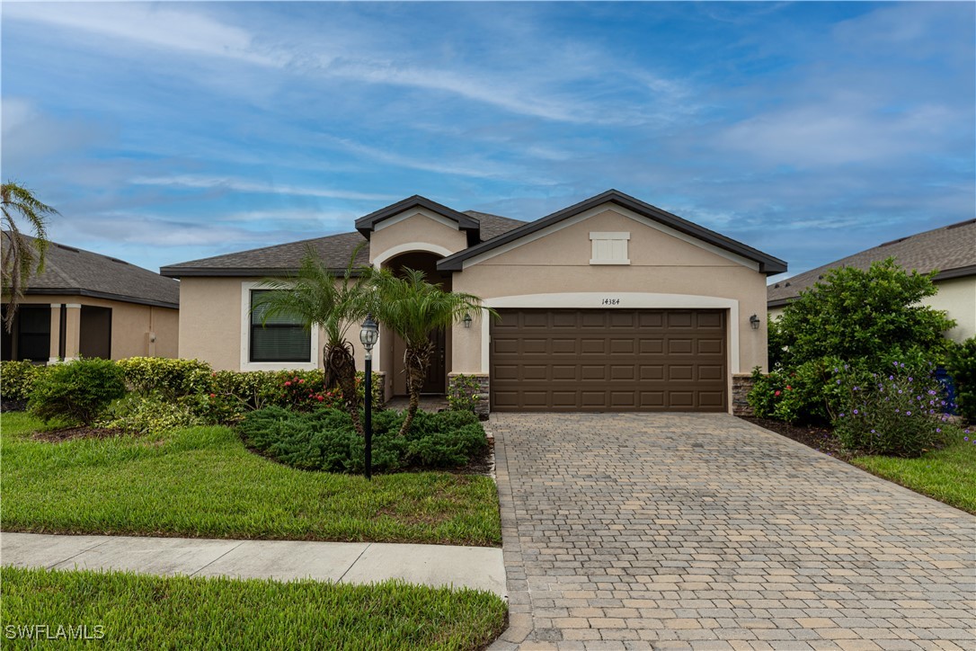 a front view of a house with a yard and garage