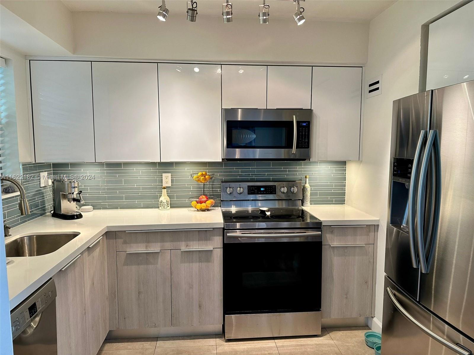 a kitchen with a sink stove and refrigerator