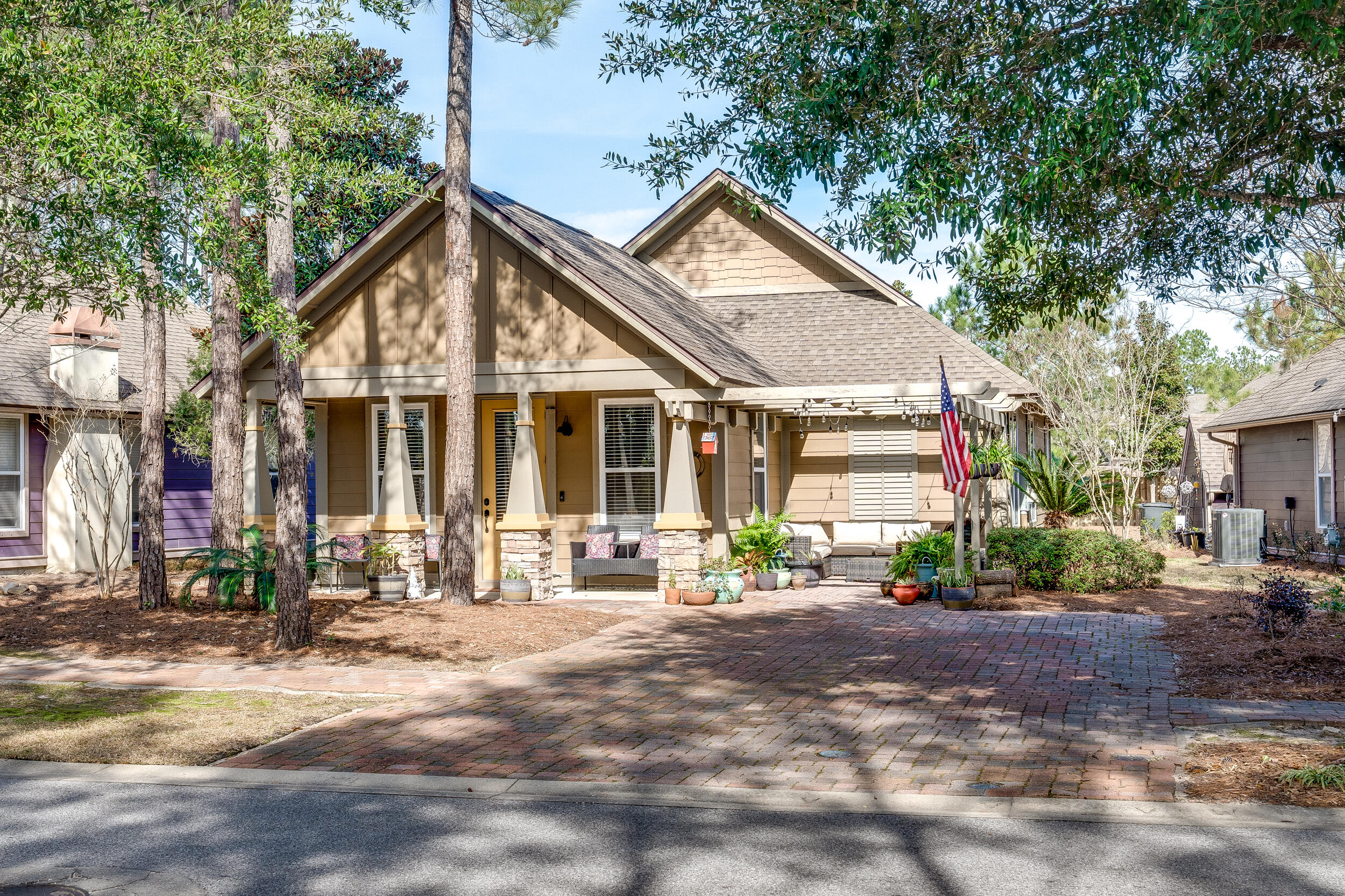 a front view of a house with a yard and outdoor seating