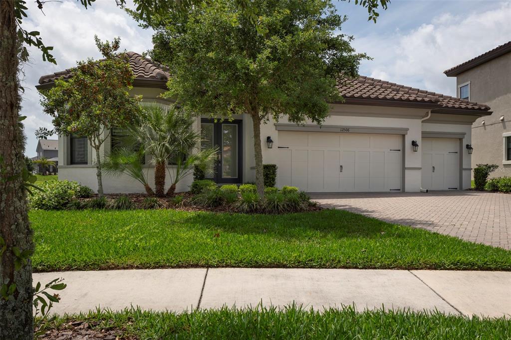 a front view of a house with a garden