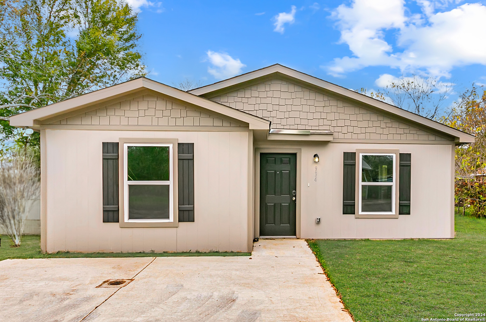 a front view of a house with garage