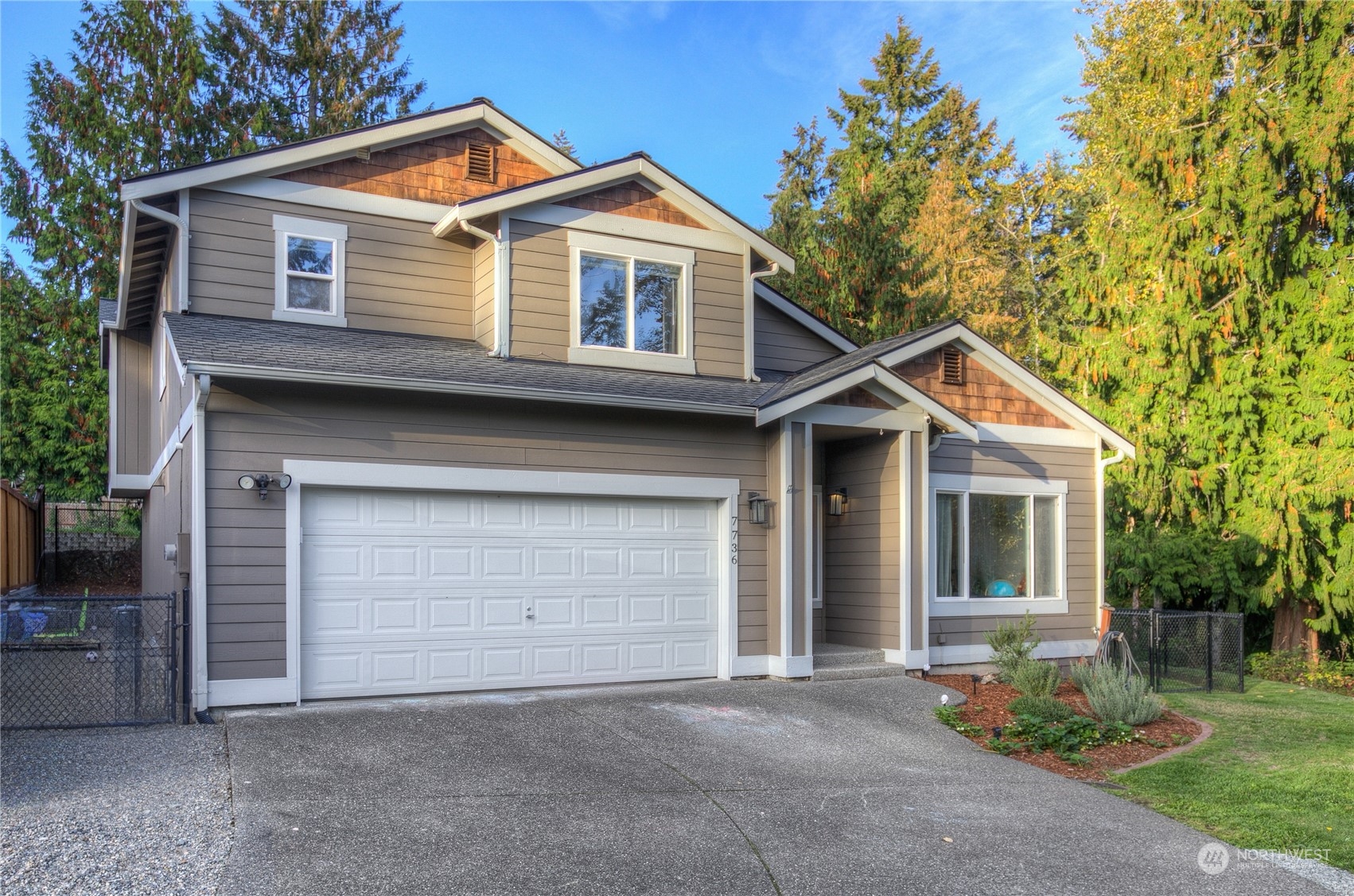 a front view of a house with garage