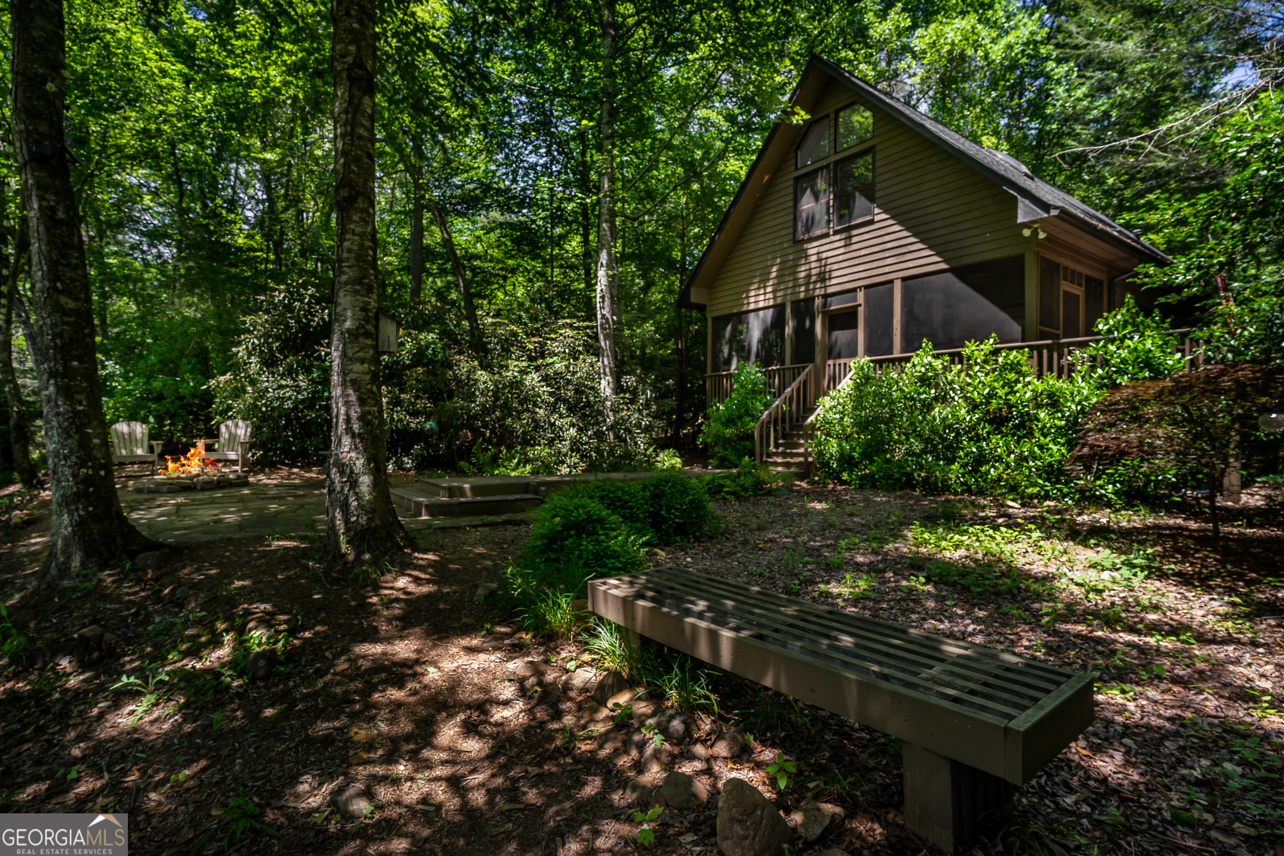 a front view of a house with a yard and green space