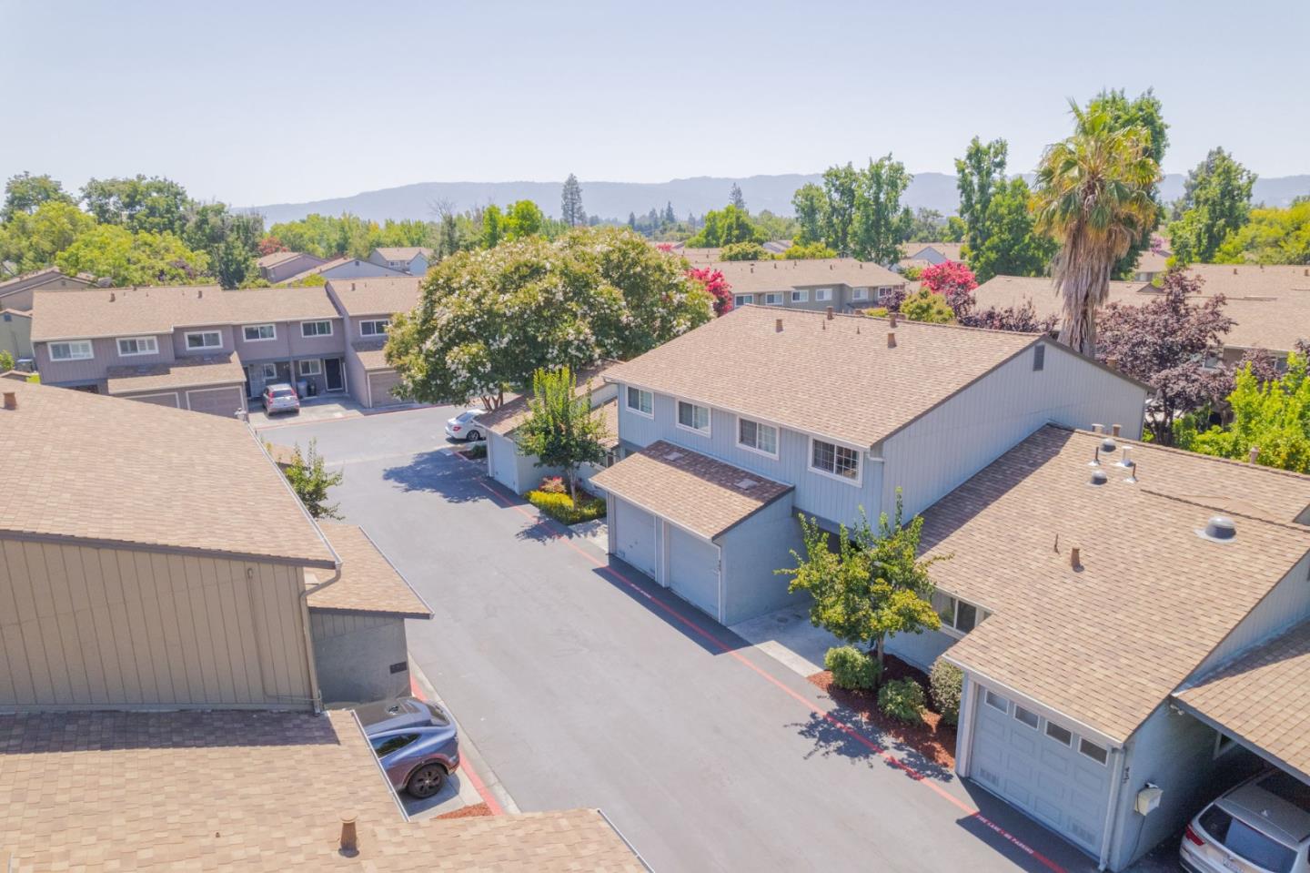 an aerial view of a house with a yard and seating space