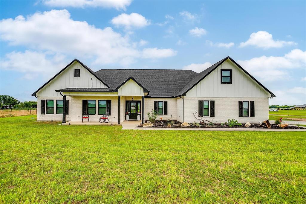 a front view of house with yard barbeque and outdoor seating