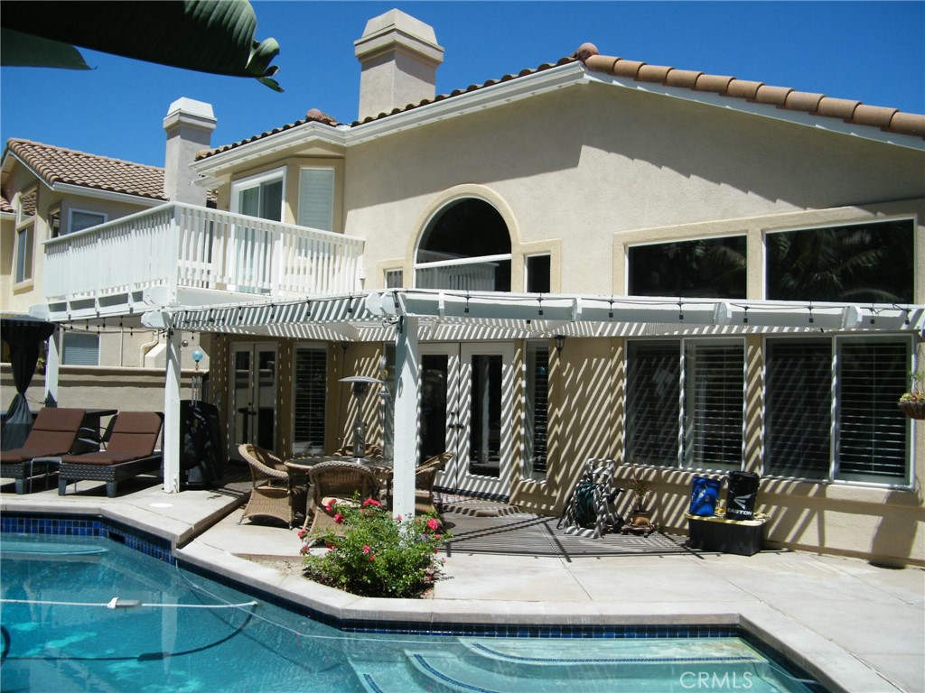 a view of house with outdoor space and swimming pool