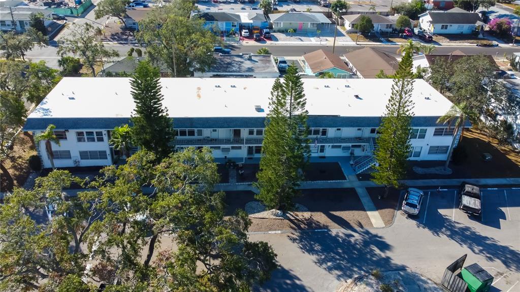 an aerial view of a house with a yard and tree s