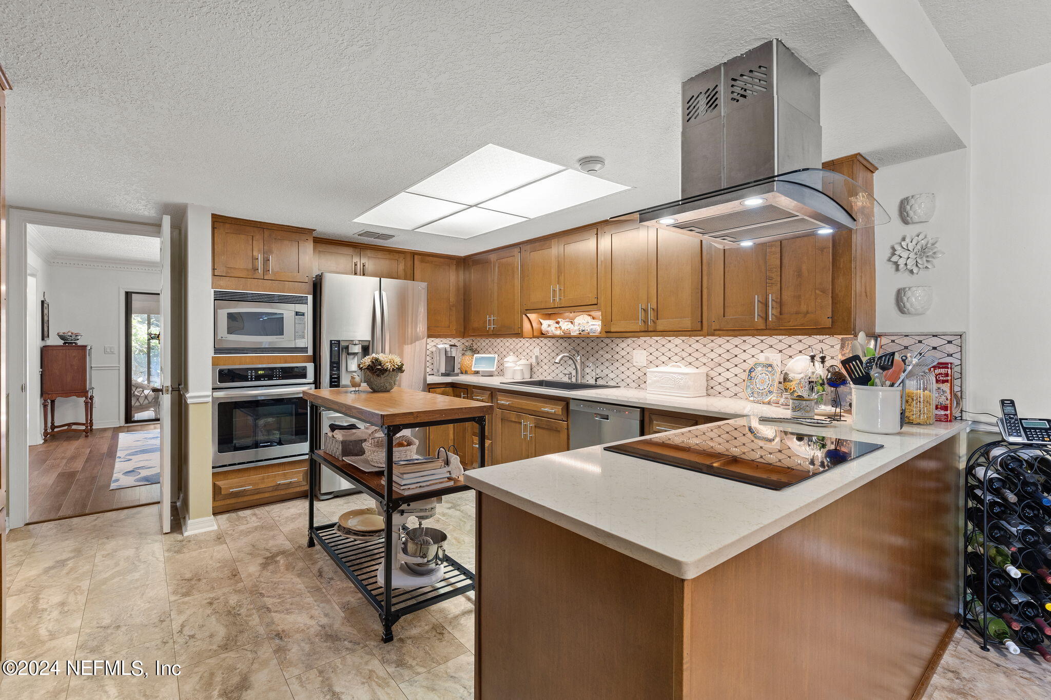 a kitchen with a sink a stove and chairs