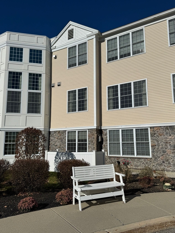 a front view of a building with a yard