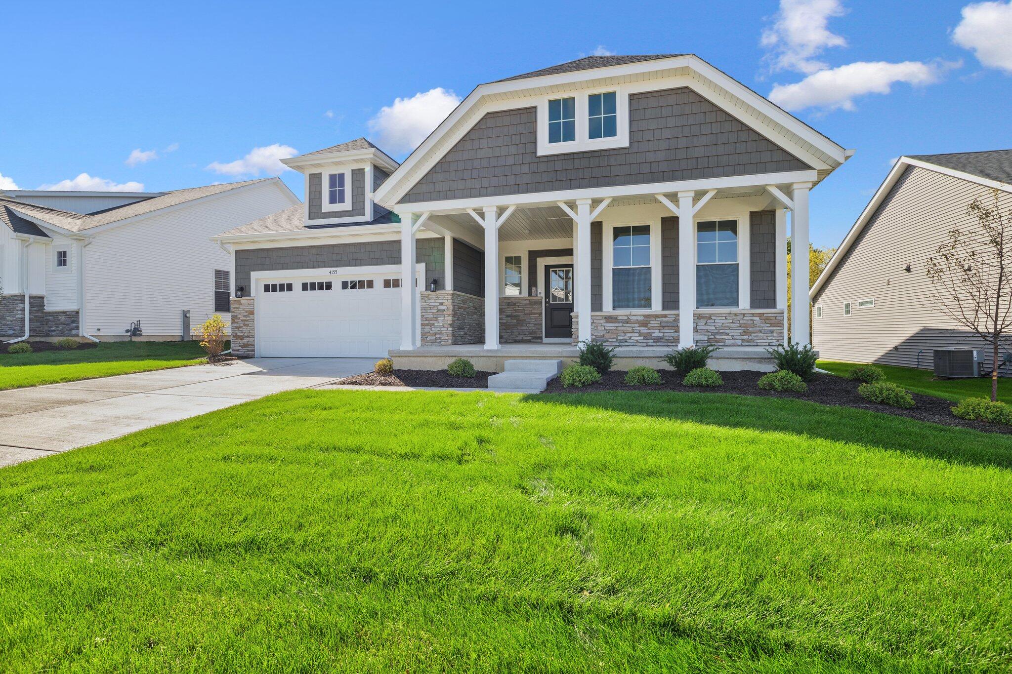 a front view of a house with a yard and porch