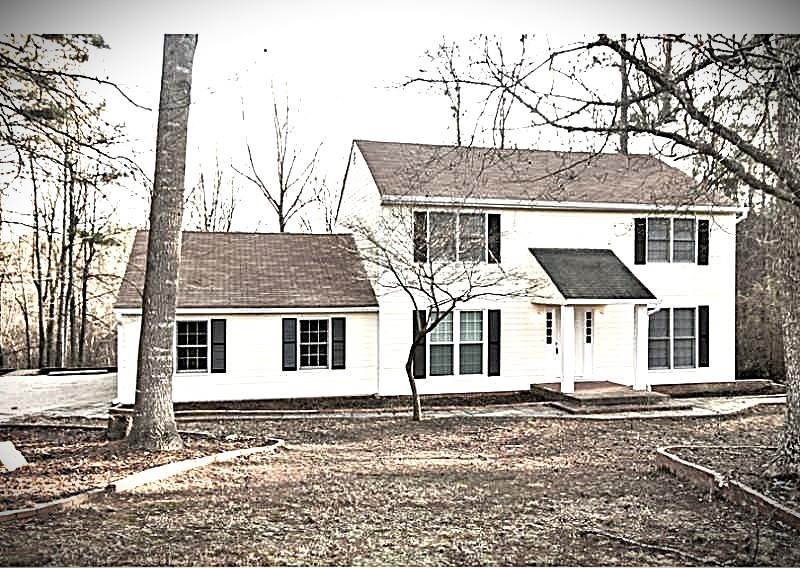 front view of a house with a bench