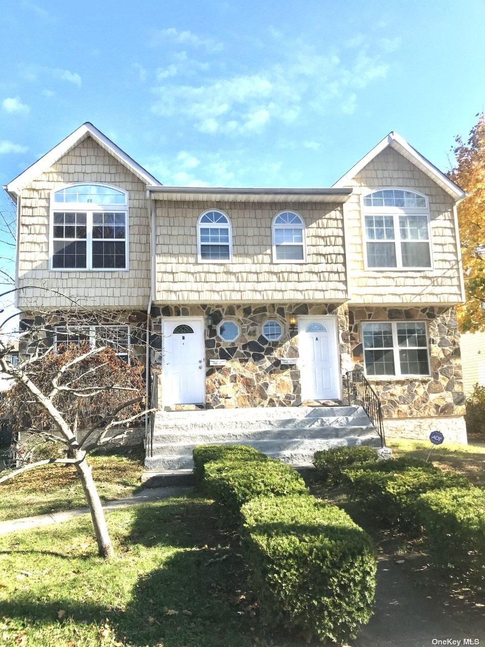 a front view of a house with a yard