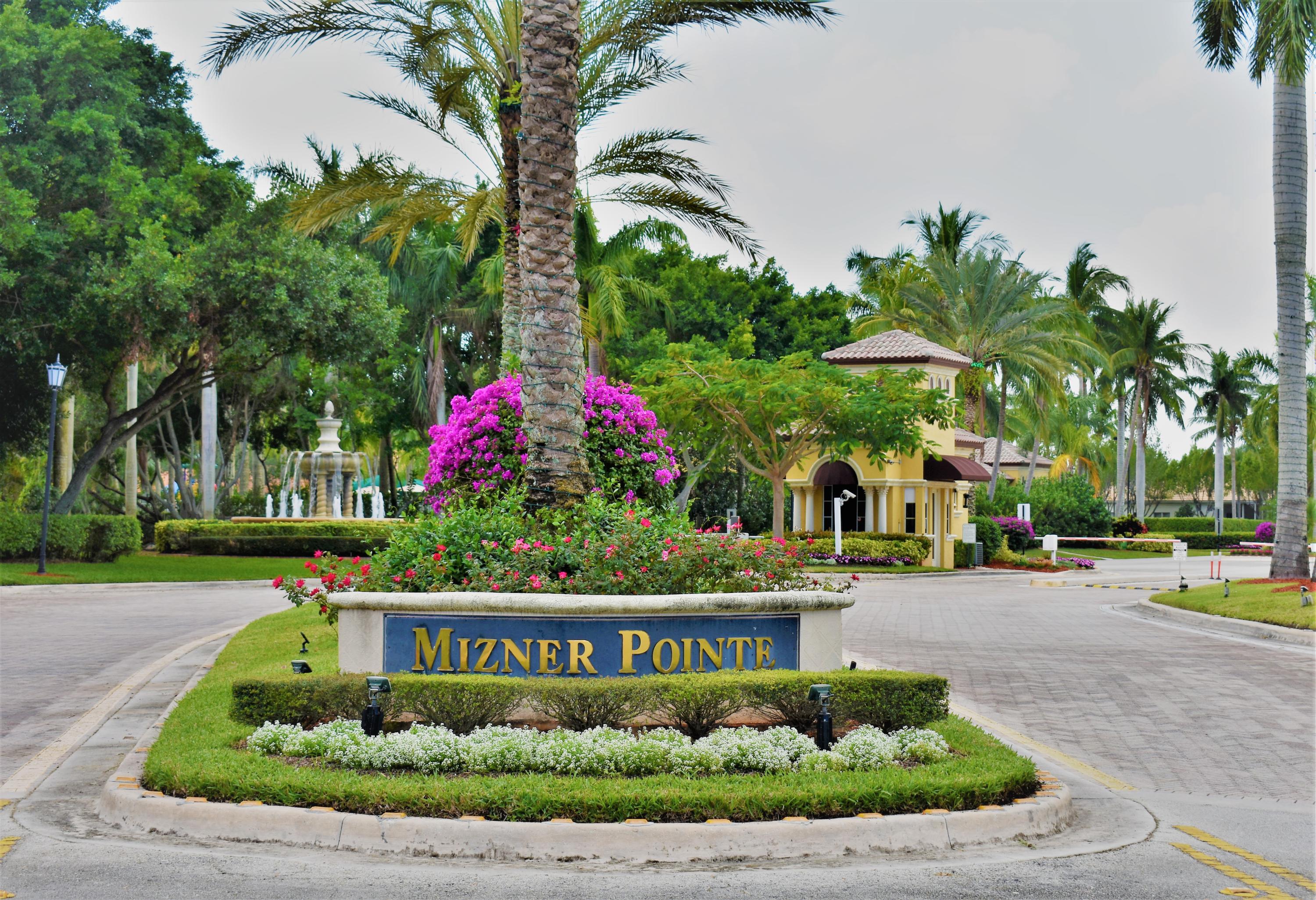 a sign that is sitting in front of flowers