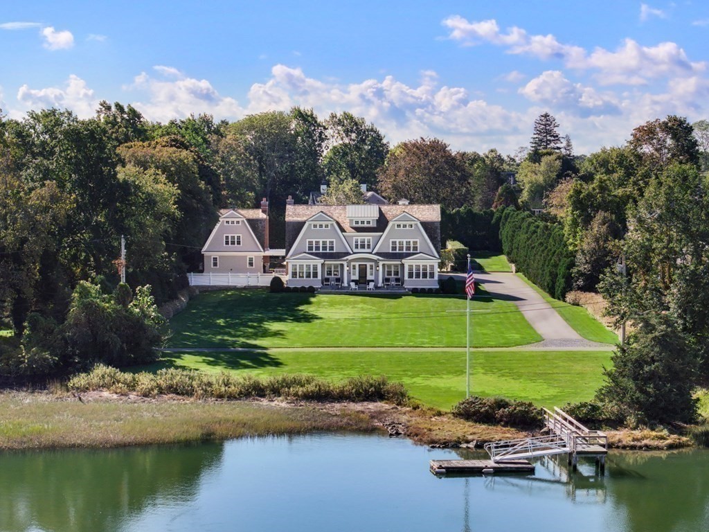 a view of a house with pool and a yard