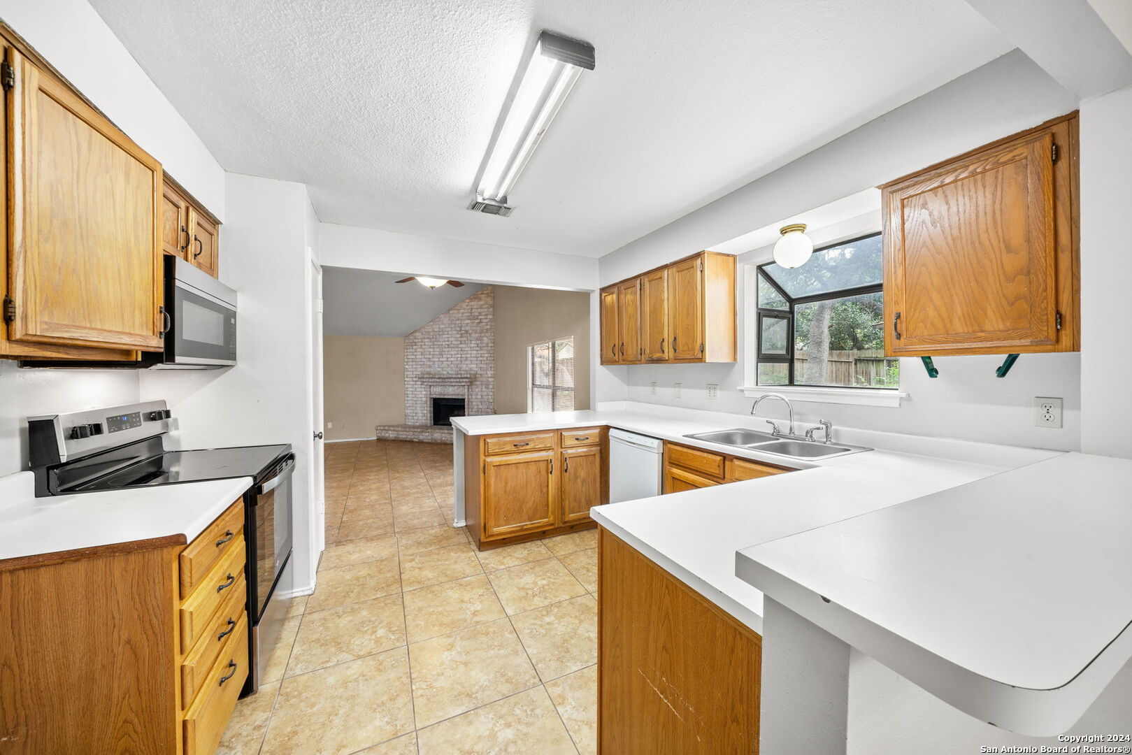 a kitchen with a sink a stove and cabinets