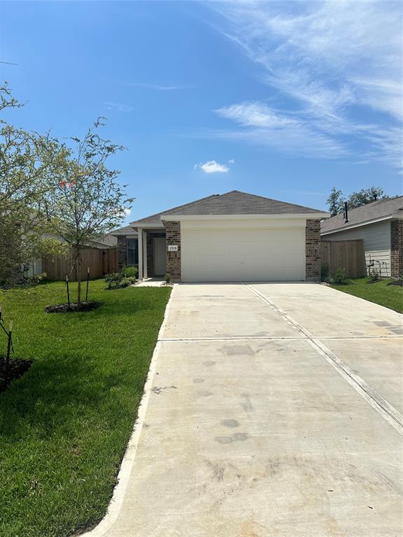 a front view of a house with a yard and trees