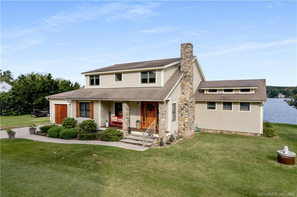 a front view of house with yard and green space