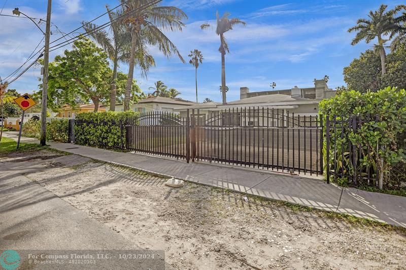 a view of a pathway with a wrought fence