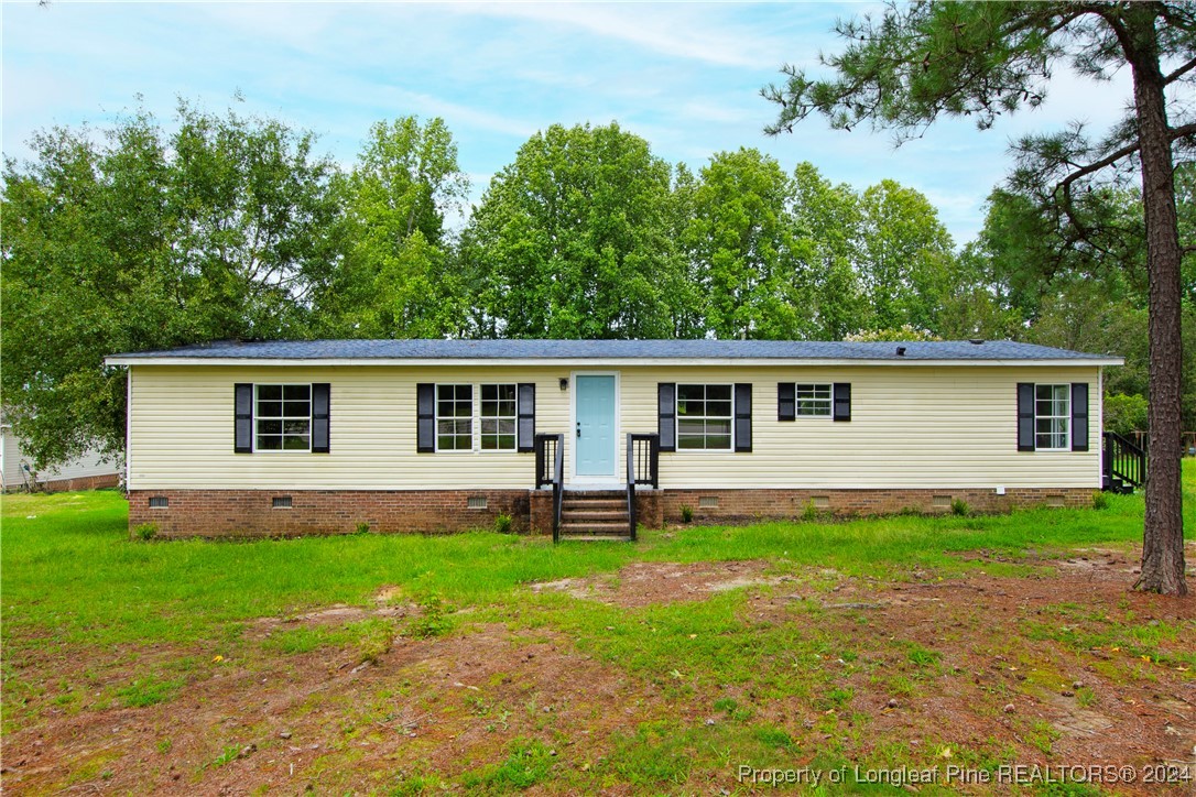 a front view of house with yard and green space