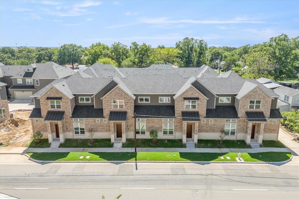 a aerial view of a house next to a yard