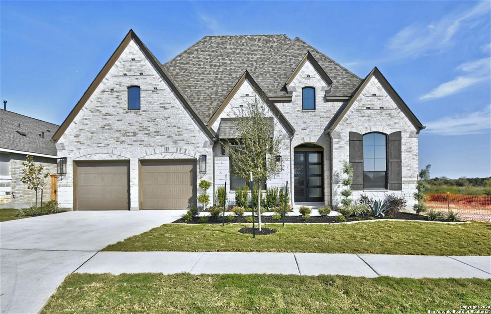 a front view of a house with a yard