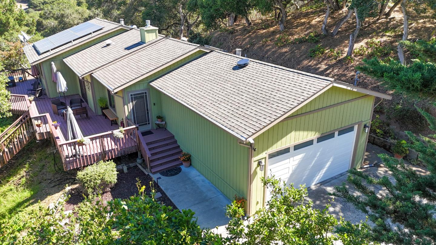 a aerial view of a house with a yard and balcony