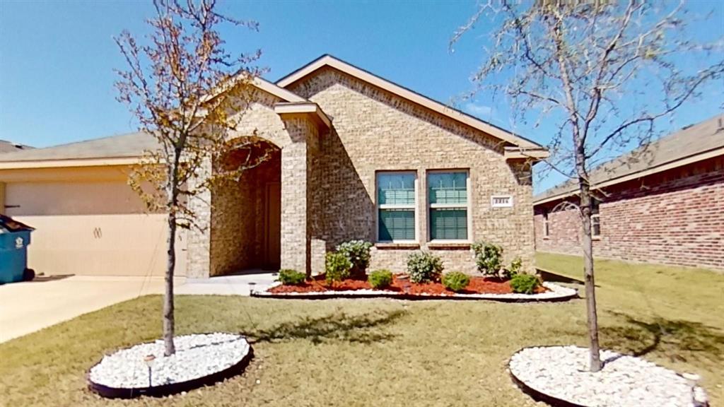 a front view of a house with a yard balcony