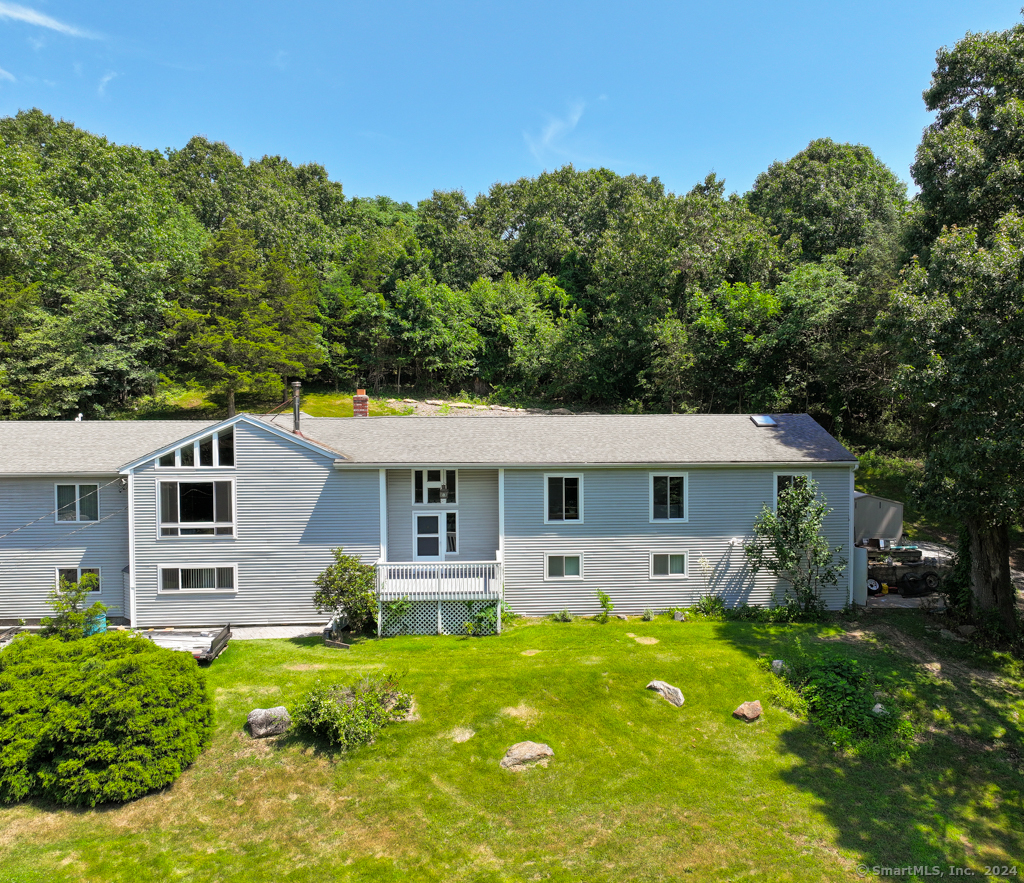 a front view of house with yard and green space