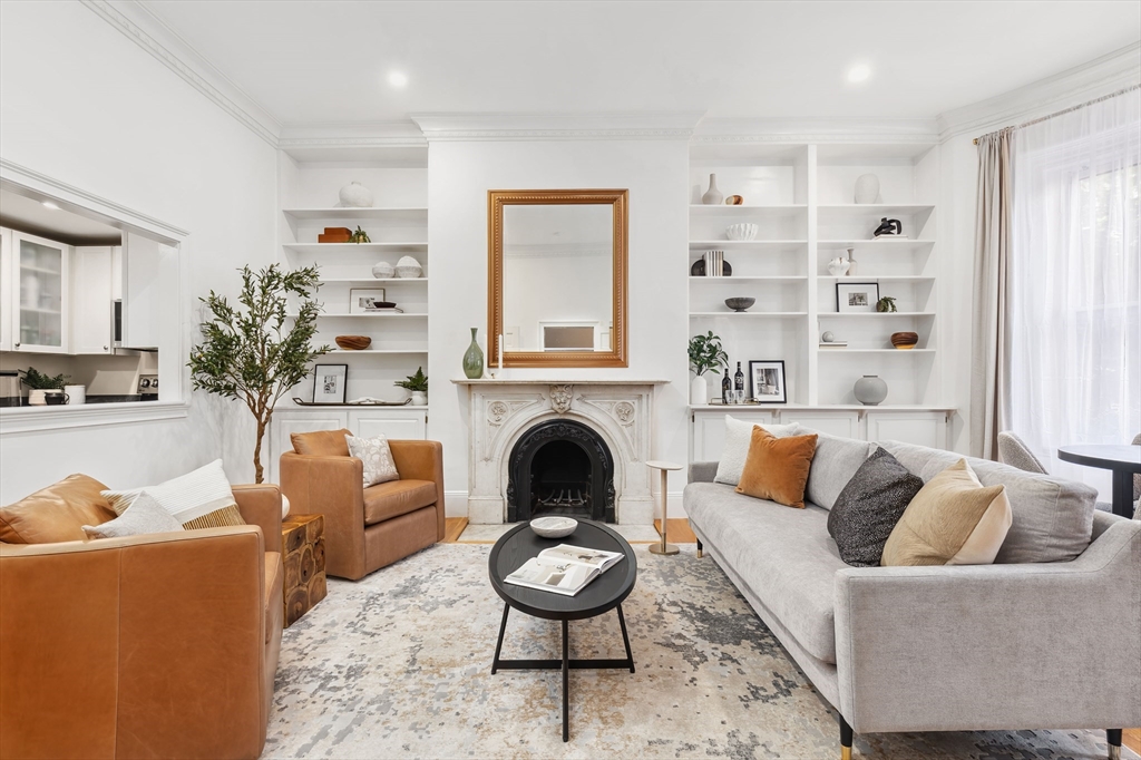 a living room with furniture a fireplace and window