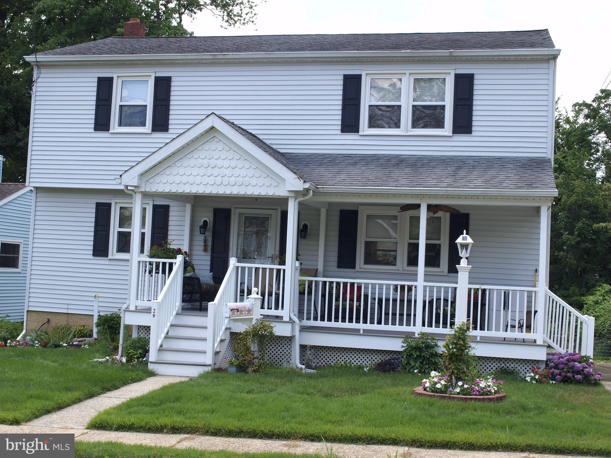 a front view of a house with a garden and deck