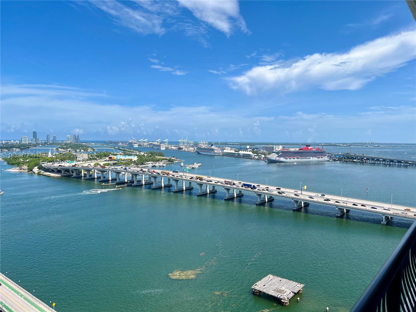 an aerial view of water body with boats and residential houses with outdoor space