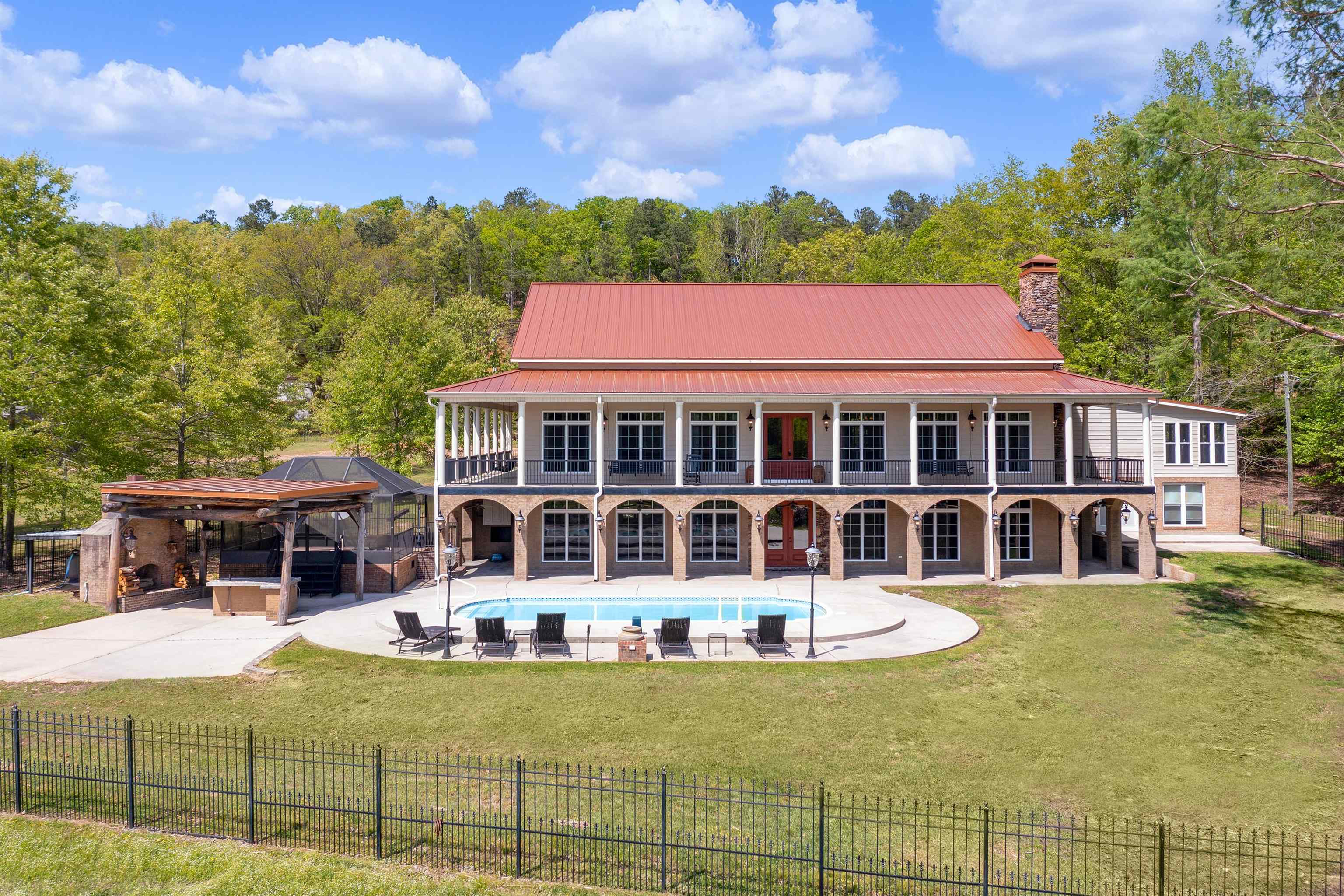 a view of a house with swimming pool and sitting area