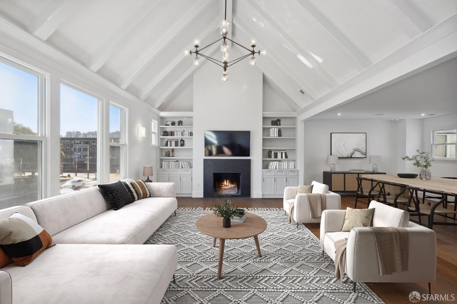 a living room with furniture a fireplace and a large window